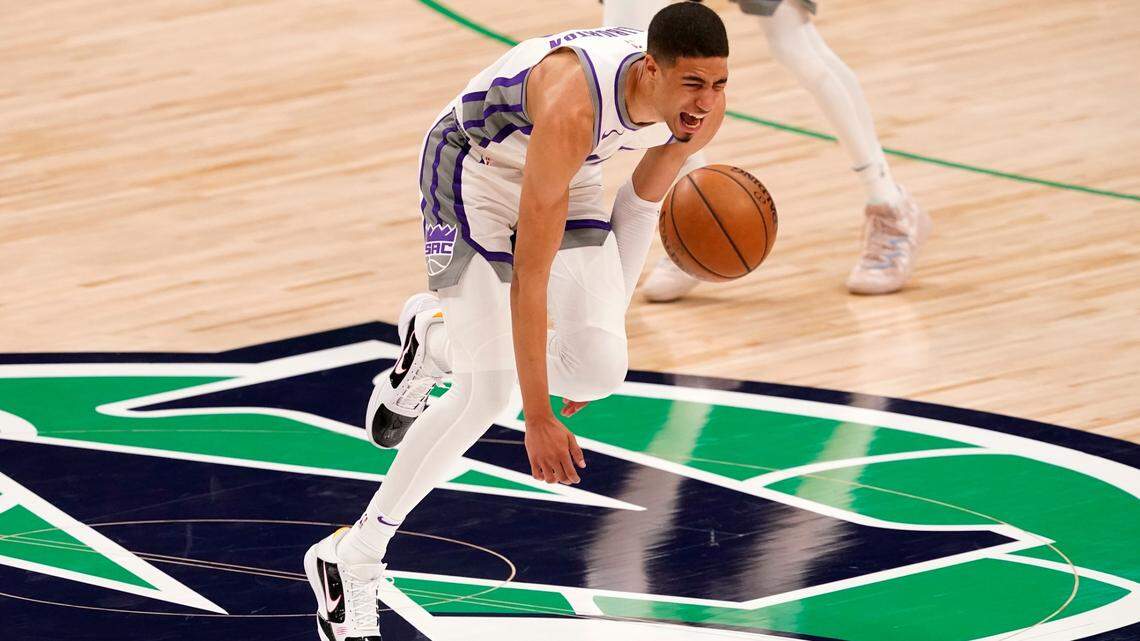 Sacramento Kings guard Tyrese Haliburton (0) loses control of the dribble and falls to the ground after suffering an unknown lower leg injury in the second half of an NBA basketball game against the Dallas Mavericks in Dallas, Sunday, May 2, 2021. (AP Photo/Tony Gutierrez)