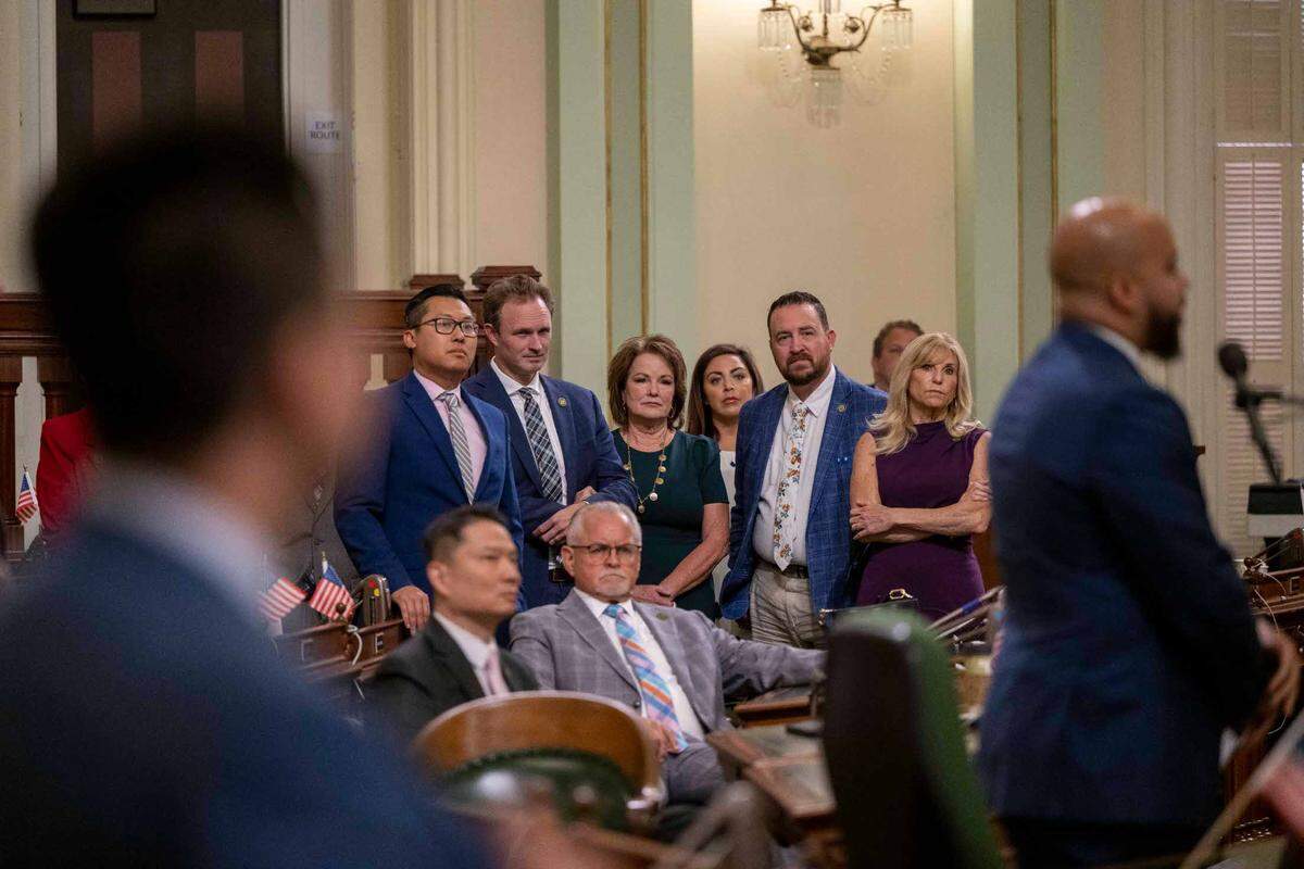 Legislators, including, Assembly Republican Leader James Gallagher of Yuba City, second from left in center, and Senate Bill 17 author Sen. Shannon Grove, R-Bakersfield, center, listen to speakers during an Assembly session at the Capitol on Thursday prior to a vote to revive the child sex trafficking bill that was killed by California Democrats but caught the attention of Gov. Gavin Newsom who intervened.