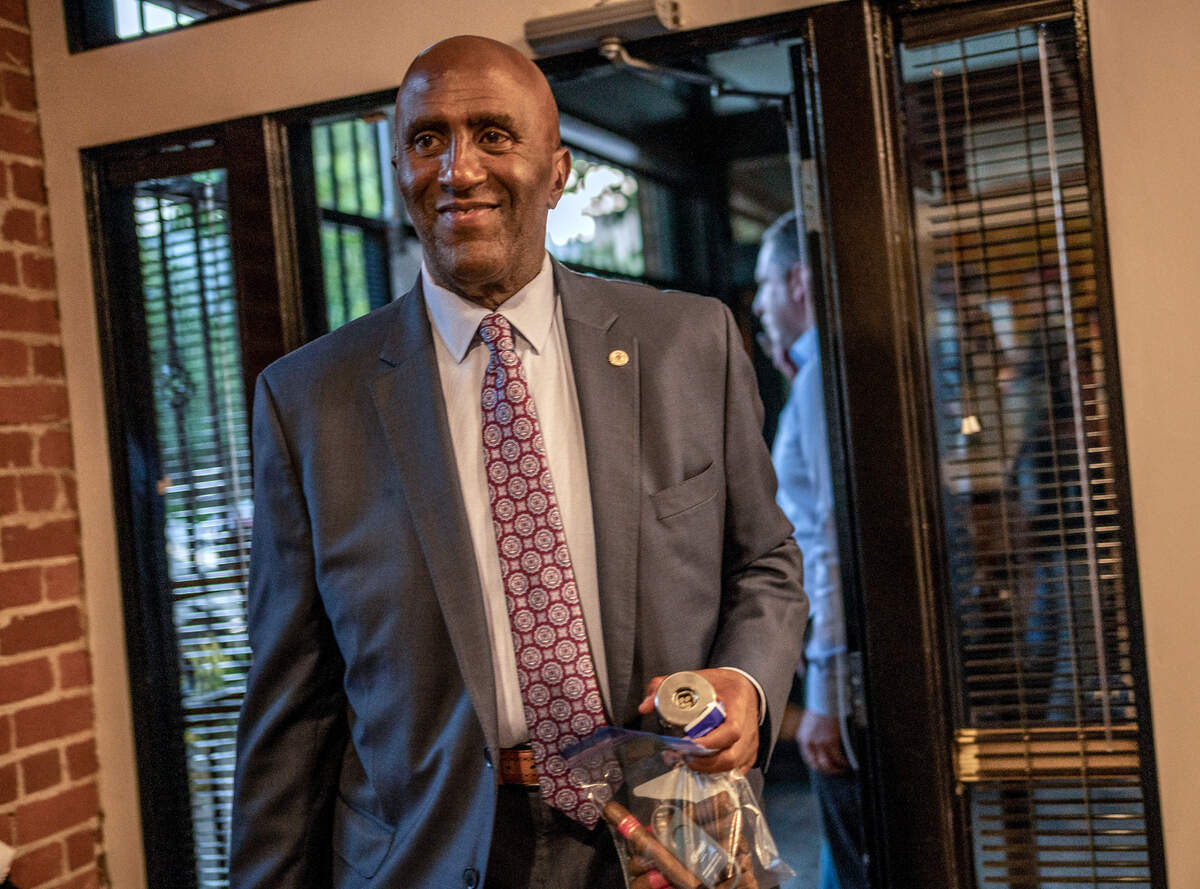 Sacramento County Sheriff candidate Assembly member Jim Cooper arrives with a bag of cigars as he celebrated early election night results in Sacramento on Tuesday, June 7, 2022.