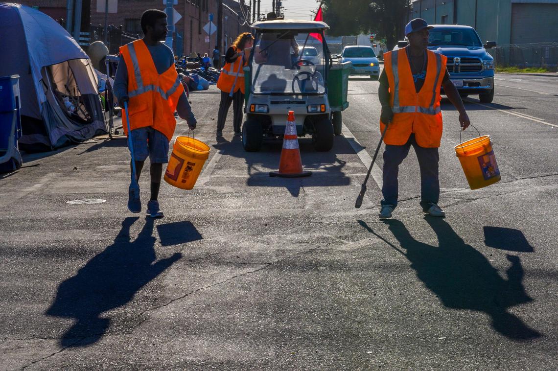 A homeless crew picks up trash as part of their community service hours along North B Street in Sacramento on Thursday, Sept. 26, 2019. “The city doesn’t pick up the trash in this area so if we didn’t do it, it would remain on the streets,” said Joe Snyder, an outdoor supervisor for the community service program at Loaves and Fishes.
