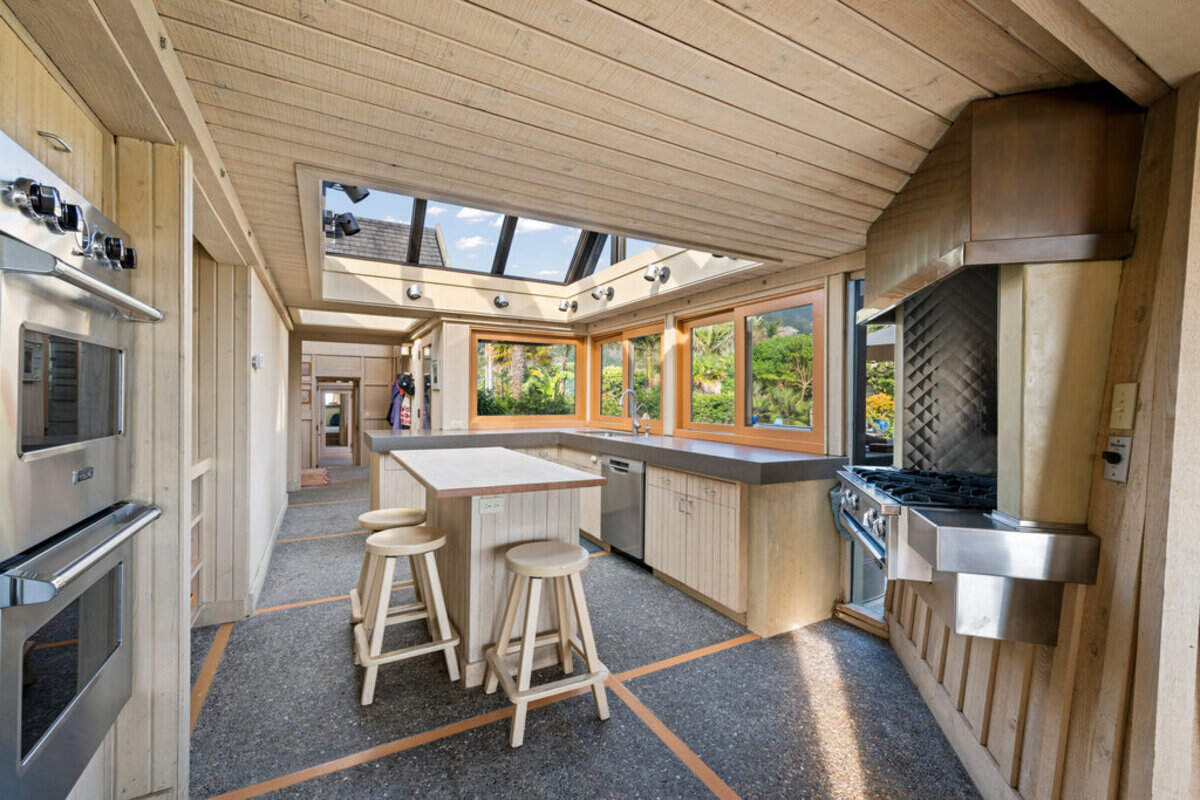 The kitchen holds mountain and the ocean views while cooking or eating.