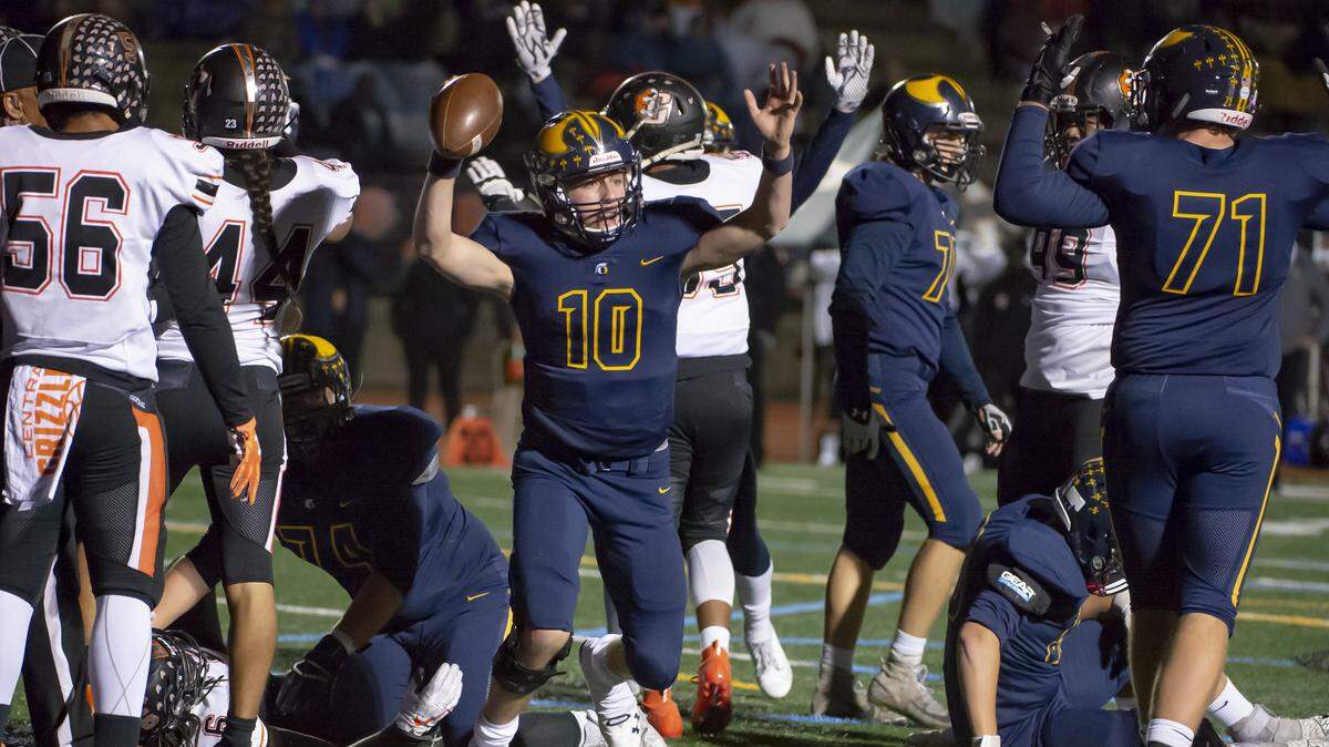 Oak Ridge Trojans quarterback Justin Lamson (10) celebrates his touchdown run during the first quarter of a CIF State Division I-AA NorCal Regional game against Central of Fresno on Friday, Dec. 6, 2019, in El Dorado Hills.