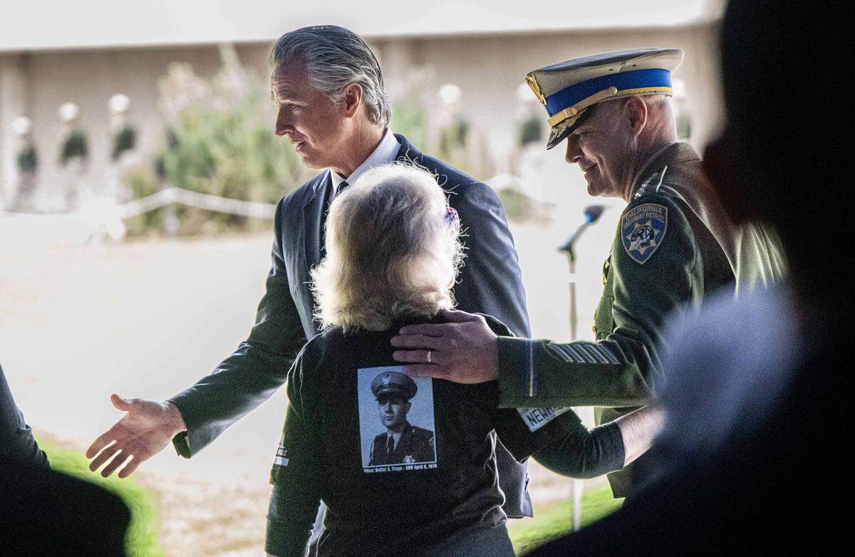 Gov. Gavin Newsom and California Highway Patrol Commissioner Sean Duryee talk to family members of fallen officers during the CHP Memorial Ceremony in West Sacramento on Tuesday, May 5, 2026.