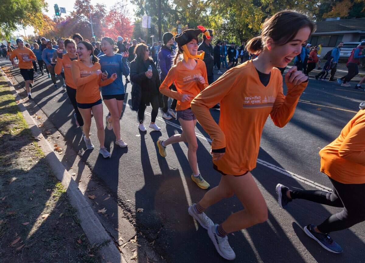 Runners make their way down J Street during the Run to Feed the Hungry in Sacramento on Thursday.