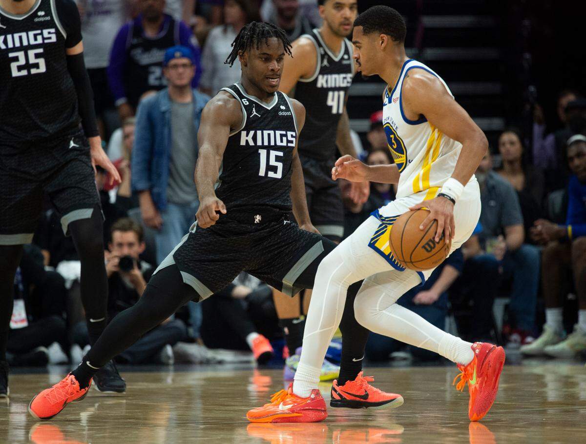 Sacramento Kings guard Davion Mitchell (15) defends against Golden State Warriors guard Jordan Poole (3) during Game 1 of the first-round NBA playoff series at Golden 1 Center on Saturday, April 15, 2023.