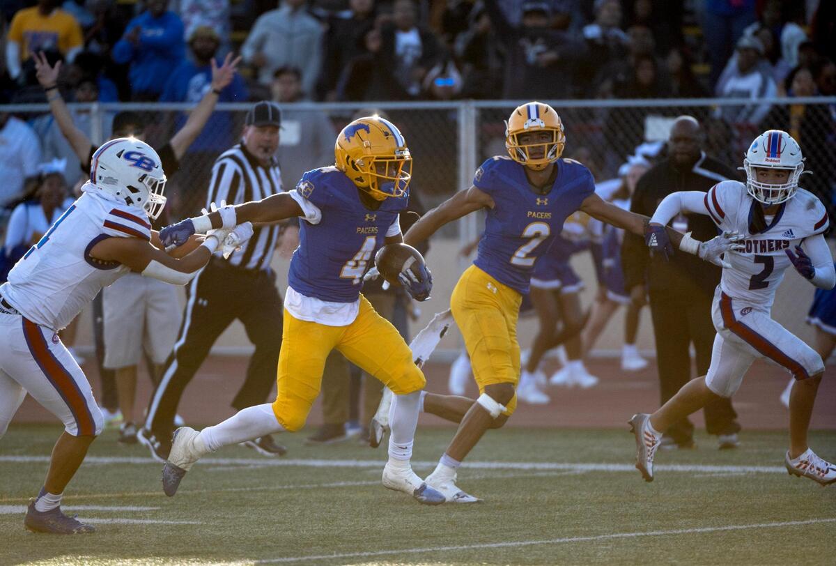 Grant High School’s Semaj Mafu-Hart runs for a touchdown after escaping Christian Brothers’ Marcus Price and Isaiah Jordan during the CIF Sac-Joaquin Division III section championship at Hughes Stadium in Sacramento on Friday.