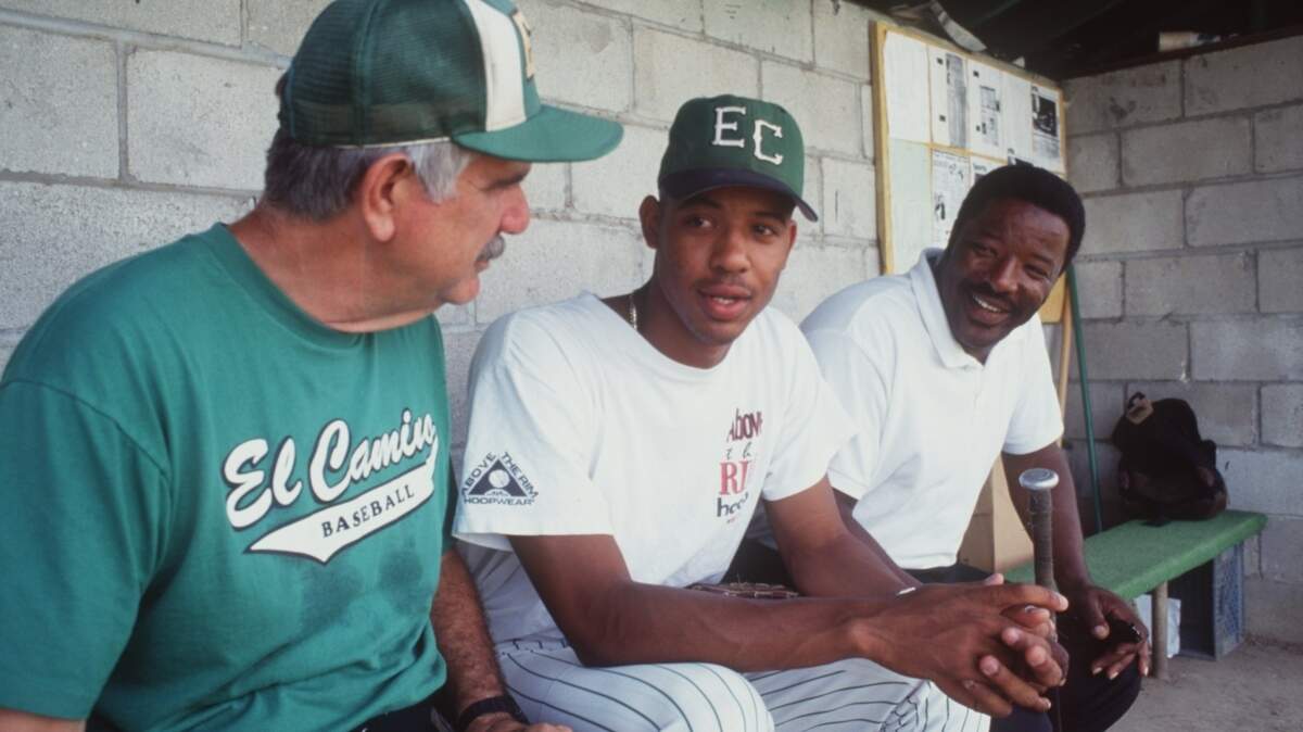 El Camino baseball coach Frank Calcagno with Derrek Lee, center and Derrek’s father, Leon Lee, in the dugout in May 1993.