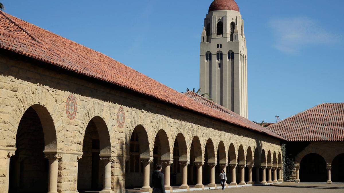 People walk on the Stanford University campus beneath Hoover Tower in 2019. An Alabama man is accused of posing as a student to live in Stanford University dorms for 10 months, reports say.