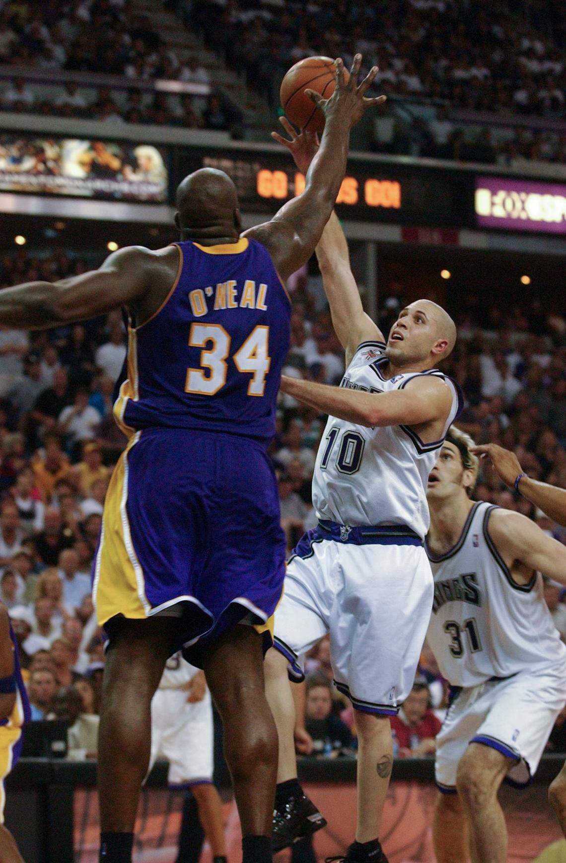 Mike Bibby shoots past Shaquille O’Neal during game seven of the NBA Western Conference Finals between the Sacramento Kings and the Los Angeles Lakers at Arco Arena in 2002.