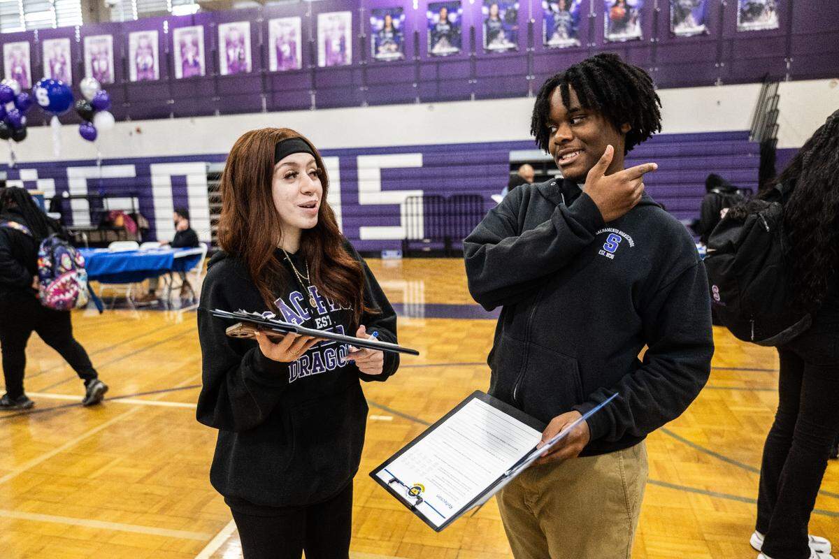 Isabella Rodriguez and Jordan Collins, students at Sacramento Charter High School, talk about their budgets during a financial literacy simulation held by Golden 1 Credit Union at the school on Wednesday.
