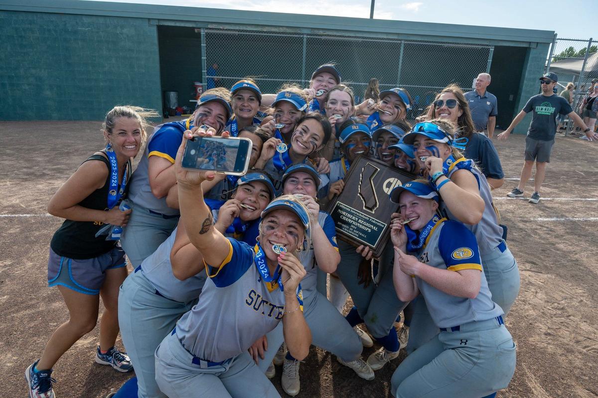 Sutter Huskies pitcher Olivia Bauer (5) takes a selfie with her team and the championship plaque after defeating the Dixon Rams for the CIF Northern California Division III softball championship on Saturday.