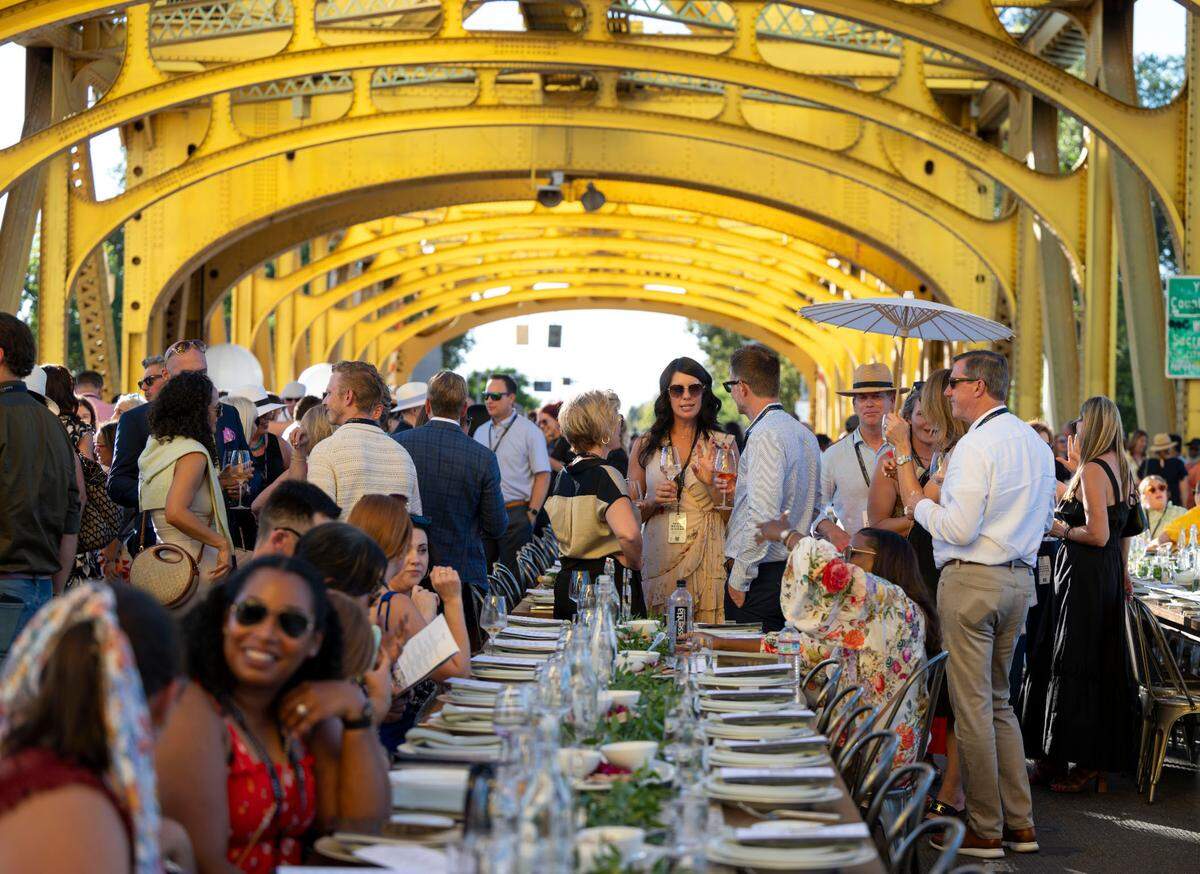 Guests talk before the start of the Farm-to-Fork’s Tower Bridge Dinner on Sunday.