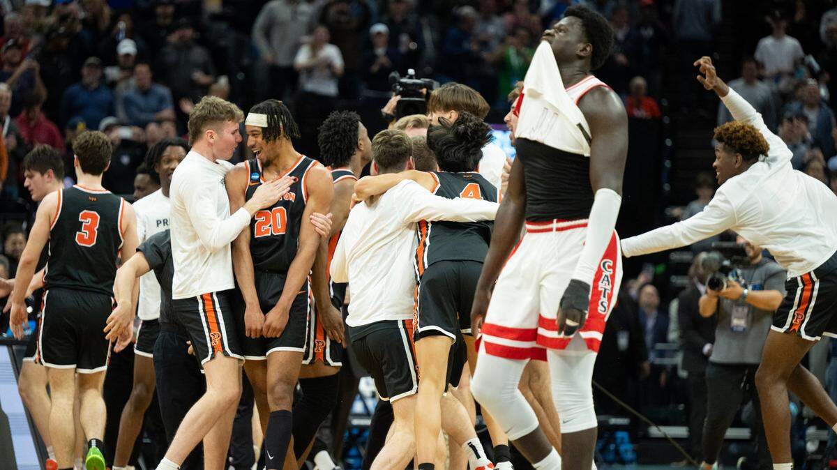 Arizona Wildcats center Oumar Ballo (11) walks by the Princeton Tigers as they celebrate their upset victory over No. 2 seed Arizona 59-55 in the first-round of the NCAA Tournament on Thursday at Golden 1 Center.
