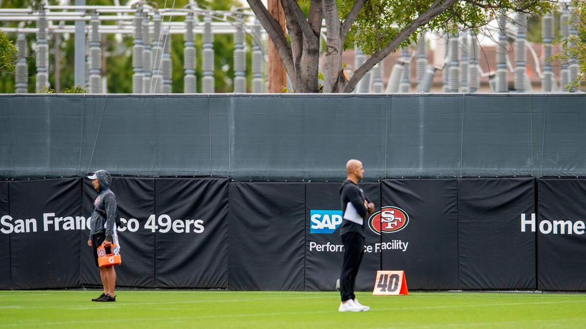 A part of an electrical substation is seen behind a fence near the San Francisco 49ers practice facility during training camp at Levi’s Stadium in Santa Clara, on Thursday, July 24, 2025. General manager John Lynch said the team will look into theories that the substation is to blame for the 49ers’ high volume of serious injuries.