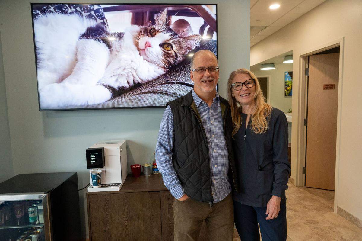 Veterinarians Chris “Shac” Shacoski and Julie Cole stand at the Tabby Tea Cat Lounge & Adoption Center in the Cat Tales Feline Health Center last month.
