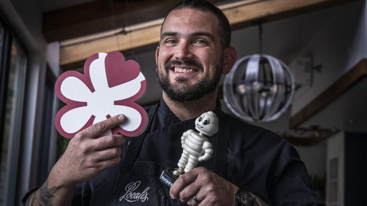 Localis chef-owner Chris Barnum-Dann holds a Michelin star and the Michelin man on Thursday, Dec. 8, 2022, at his midtown Sacramento restaurant.