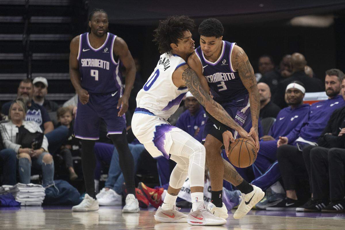 Sacramento Kings guard Killian Hayes (3) and Utah Jazz forward Andersson Garcia (0) fight for the ball during a game at Golden 1 Center in Sacramento on Sunday.