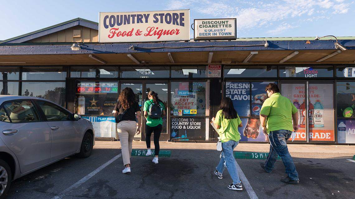 Teens trained as junior community health workers visit shops in Fresno in September. Some community health groups hope young people will become the trusted messengers in places where COVID-19 vaccine fears linger.