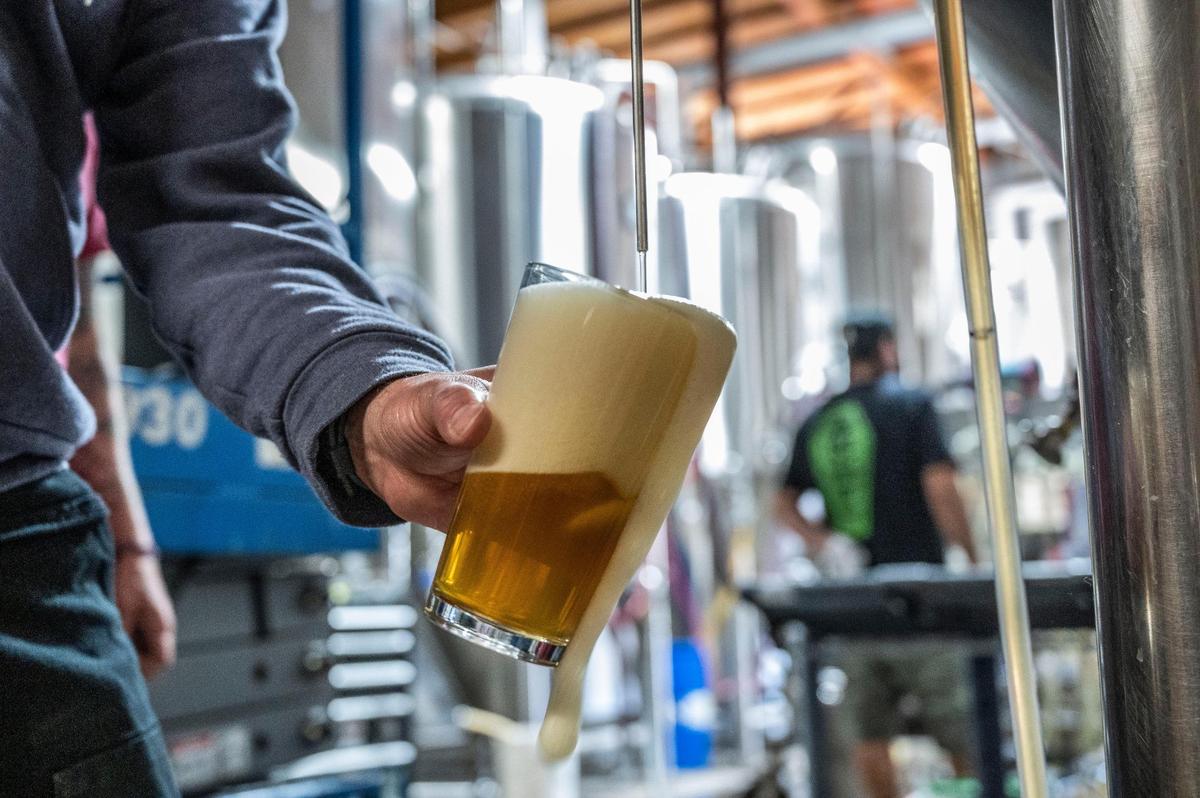 Robert Moreno, head brewer at Jackrabbit Brewing, where Onibi Japanese-inspired craft beer is made in West Sacramento, pours some beer for tasting on April 18.