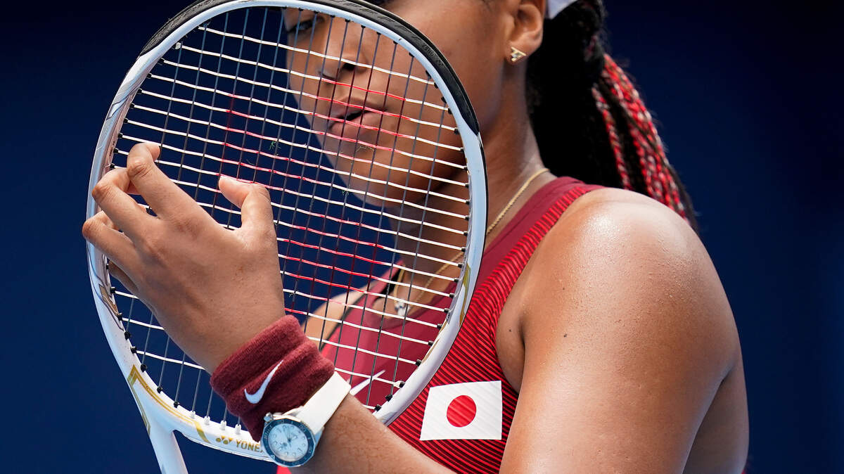 In this July 26, 2021 file photo, Naomi Osaka adjusts her racket during a second round tennis match. Osaka skipped two major tennis tournaments this year as she deals with pressure from the media and the public.