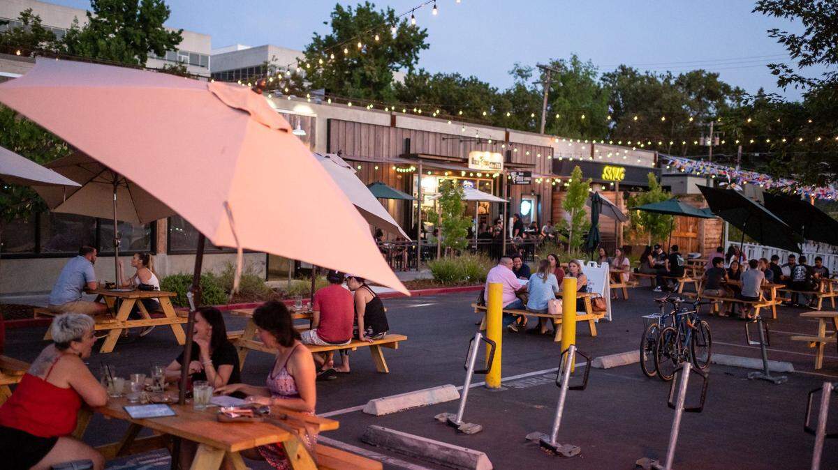 Drinkers and diners enjoy service outdoors Friday, July 17, 2020, on the 1400 block of R Street, which was closed to vehicular traffic in downtown Sacramento. The city of Sacramento is expected to extend a policy allowing more outdoor dining.