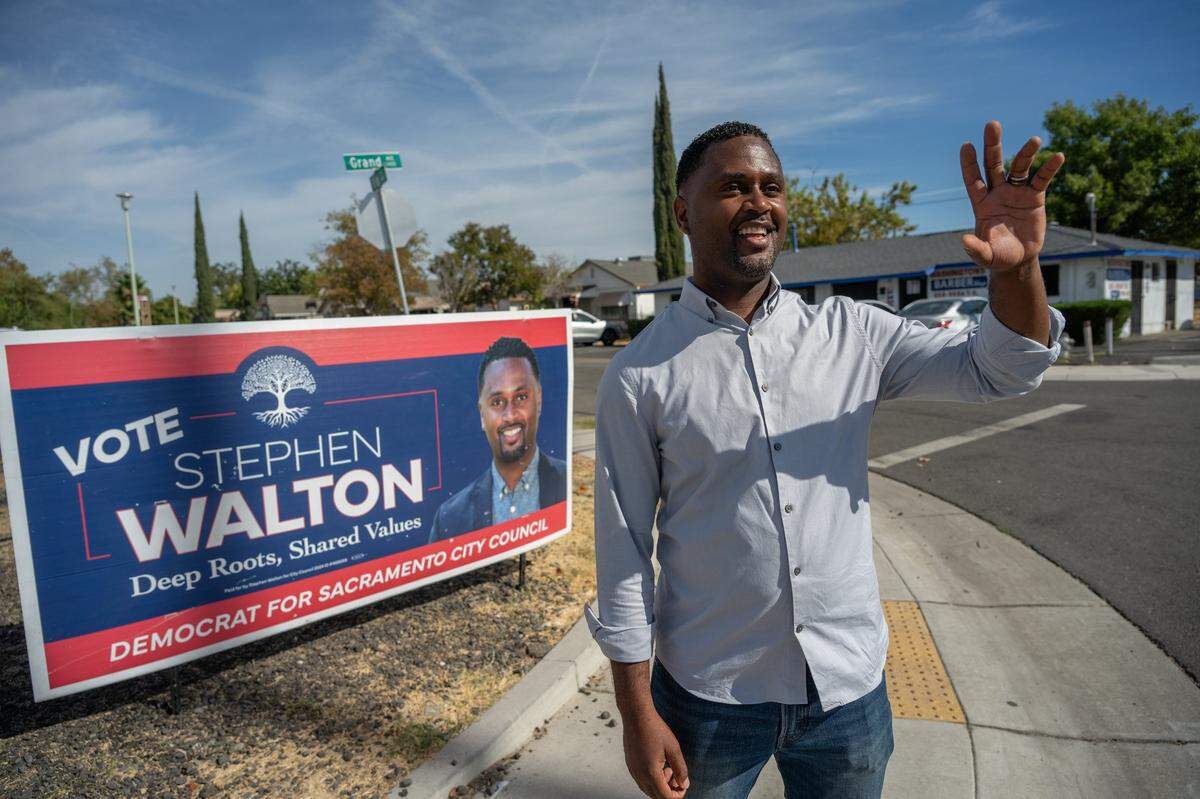 Sacramento City Council Stephen Walton waves to passersby at the corner of Grand Avenue and Fig Street in Del Paso Heights earlier this month. Walton said his family has deep roots in the community and he wants to focus on revitalization.
