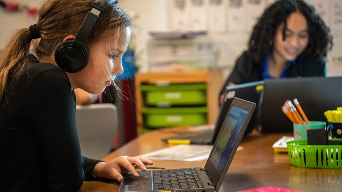 Zoe, a student at Bell Avenue Elementary in Sacramento, works with a virtual reading tutor and in-house United Way staff during the Yolo Kids Read program earlier this month.