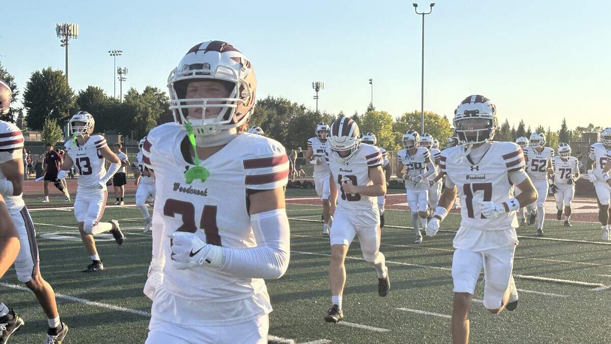 The Woodcreek Timberwolves take the field before a 37-20 win Friday against Whitney at Whitney High School in Rocklin.