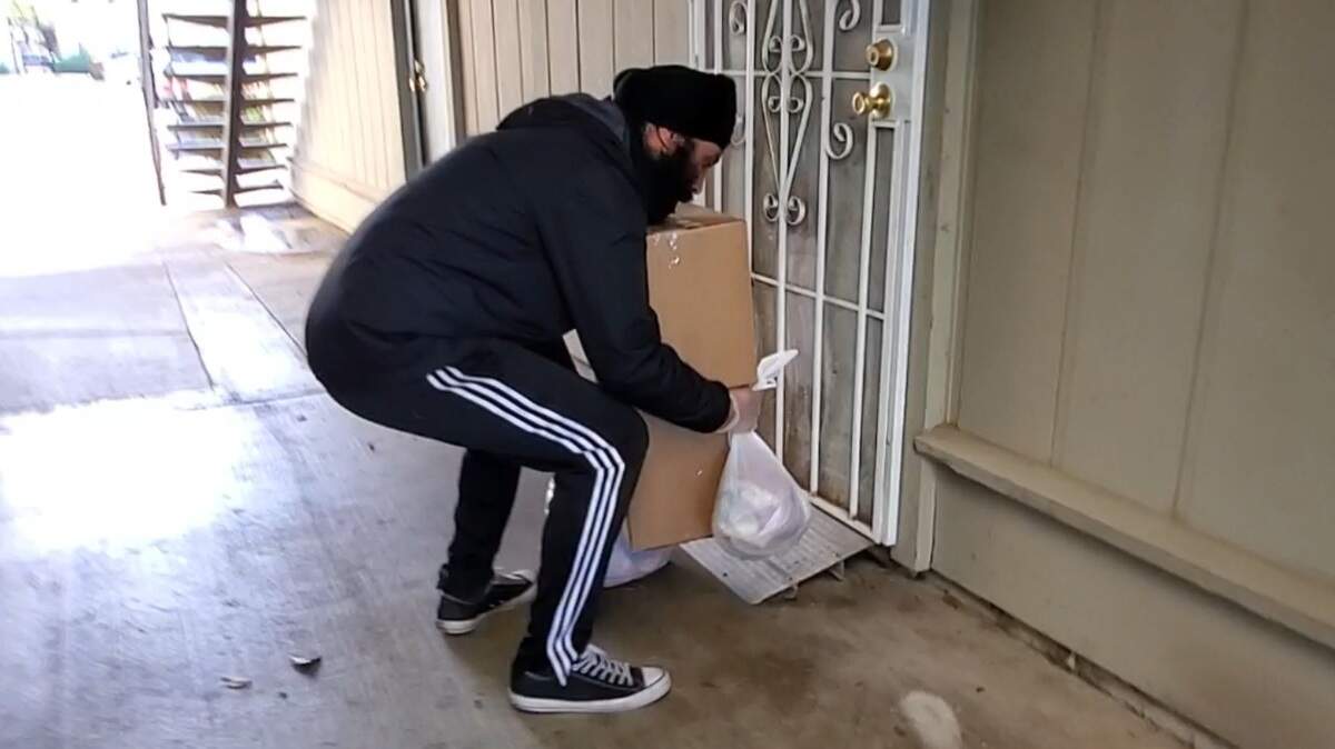 A SEVA Selfless Service volunteer delivers groceries on April 23 in Sacramento.
