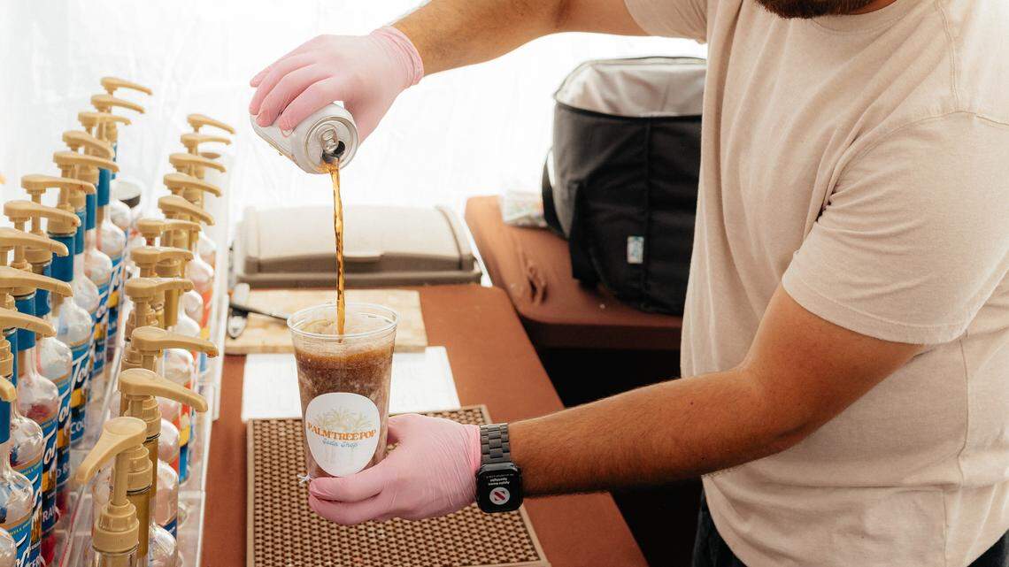 Haley Jenks’ brother-in-law, Carlos Gonzalez, pours a can of soda into a creamy dirty soda drink at a recent pop-up for Palm Tree Pop, a mobile soda business based in Fair Oaks.