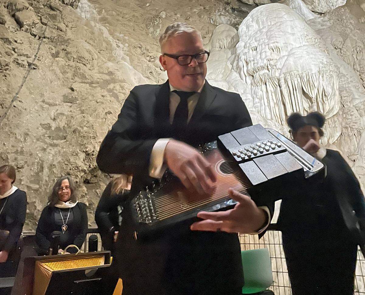 Vox Musica director and founder Daniel Paulson demonstrates a harp on Dec. 14, 2024, at the group’s annual cave concert in the Moaning Caverns in Calaveras County.