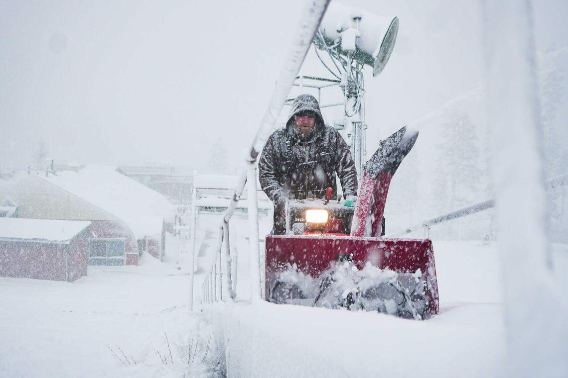 A Sierra-at-Tahoe worker clears snow with a snowblower during heavy snowfall at the base area on Tuesday, Dec. 24, 2025. A winter storm that swept through the Sierra Nevada over Christmas weekend delivered 5 feet of snow, enabling Sierra-at-Tahoe to open most of its ski terrain for the 2025-26 season.