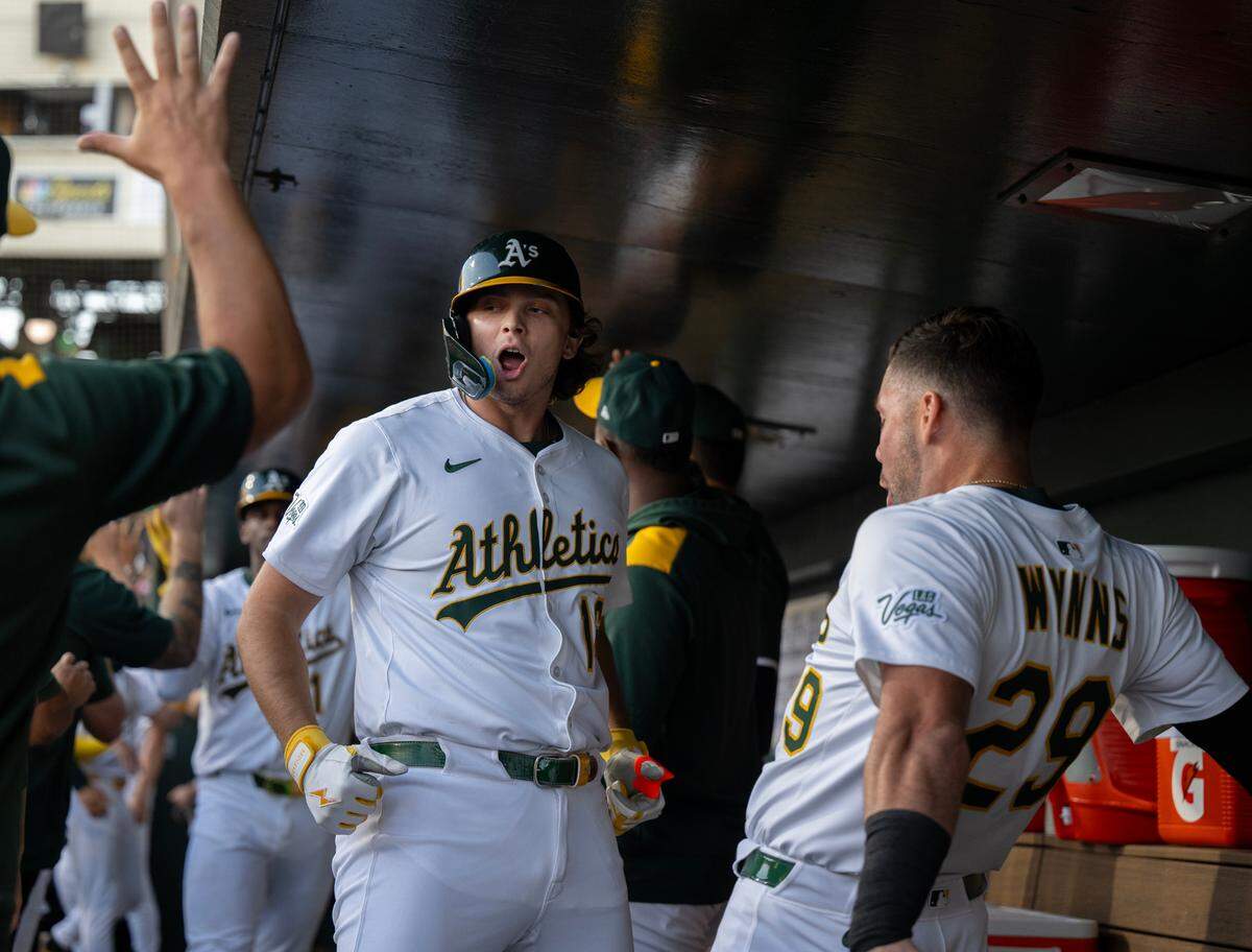 Athletics Nick Kurtz (16) celebrates with teammate Austin Wynns (29) after clearing the bases with a grand slam homer off Atlanta Braves pitcher Jesse Chavez in the bottom of the second inning on Tuesday at Sutter Health Park in West Sacramento.