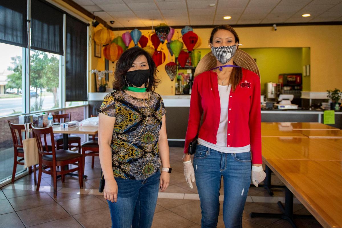 Mai Nguyen and Nikki Nguyen of Community Partners Advocate of Little Saigon Sacramento stand in Bon Mua Vietnamese restaurant, Saturday, June 6, 2020, where they helped collect and deliver meals to more than 180 seniors in the Sacramento area homebound during the COVID-19 stay-home order.