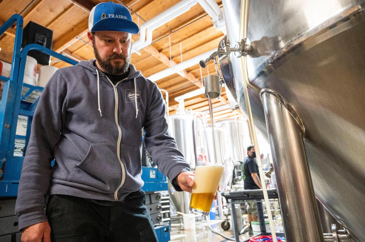 Robert Moreno, head brewer at Jackrabbit Brewing in West Sacramento where Onibi craft beer is made, pours some beer for tasting.