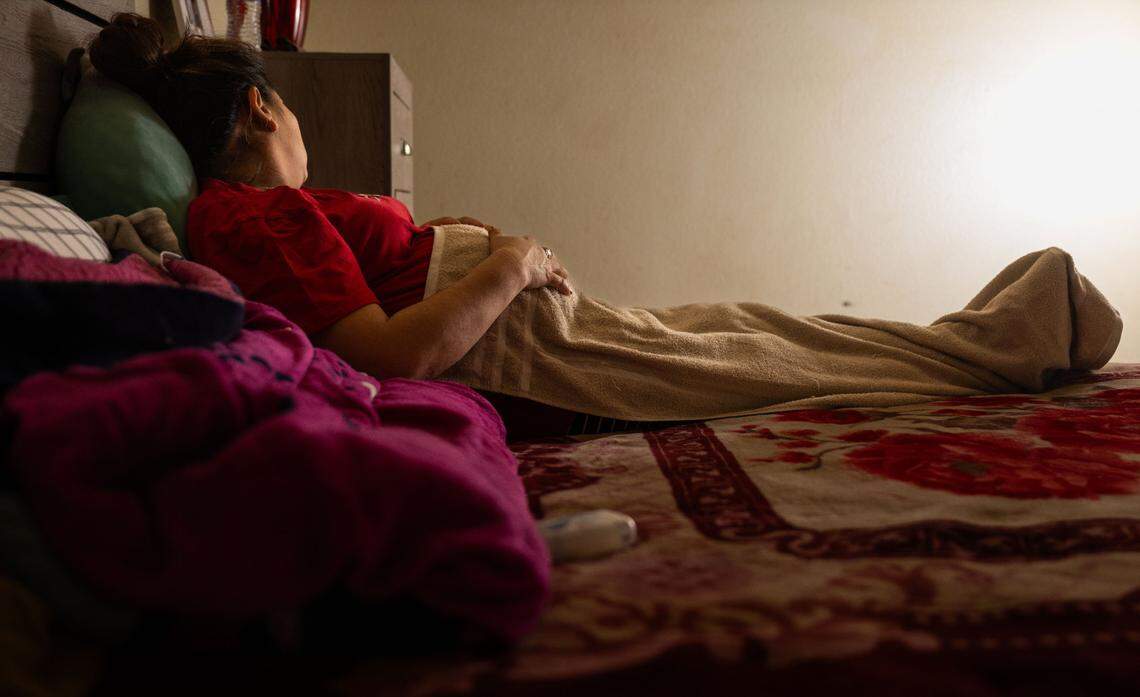 A mother, pregnant with her fourth child, lies in bed in her Sacramento home in January. She brought her three children to the United States from Mexico in 2023 to join her husband, who is also undocumented. Their son, born in May, would be the first U.S. citizen in the family under the longtime constitutional guarantee of birthright citizenship. The family has requested anonymity for fear of deportation.