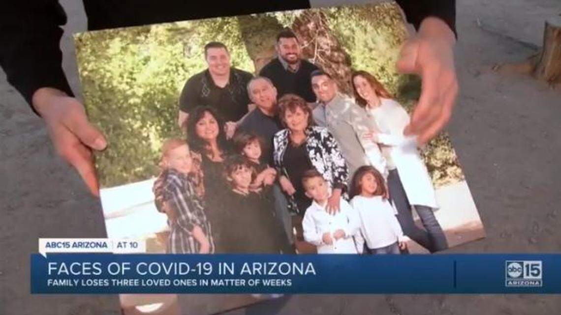 Freddy Delgado holds a photo of his Arizona family, which lost its father, mother and grandmother to COVID-19 within three weeks in December.