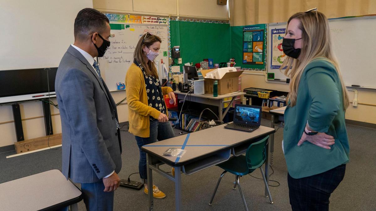 Sacramento City Unified School District Superintendent Jorge A. Aguilar watches a demonstration at H.W. Harkness Elementary in south Sacramento on Friday, March 26, 2021, from instructional tech coordinator Nova Katz and district spokeswoman Tara Gallegos on the new cameras the district is deploying to help blur the lines between in-person and distance learning in the classroom.