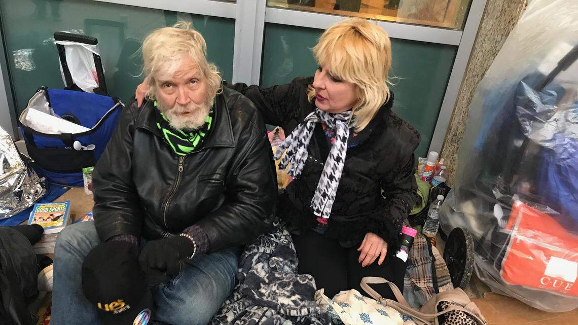 Gerald Reid and Yvonne Barbeau, who have been sleeping outside City Hall since the fall, sit outside the building on Feb. 26, 2019.