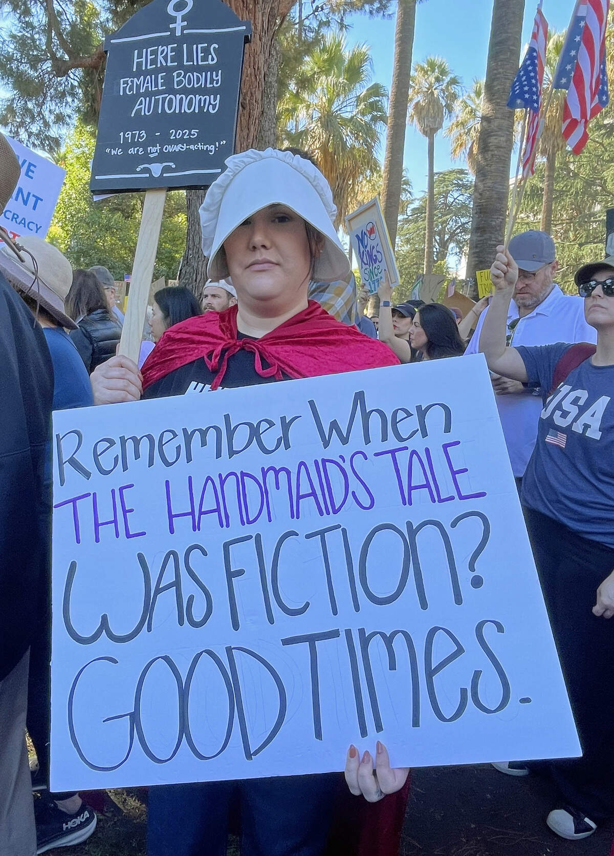Brittany Shaw wears a “Handmaid’s Tale” costume at the “No Kings” protest at the Capitol in Sacramento Oct. 18, 2025.