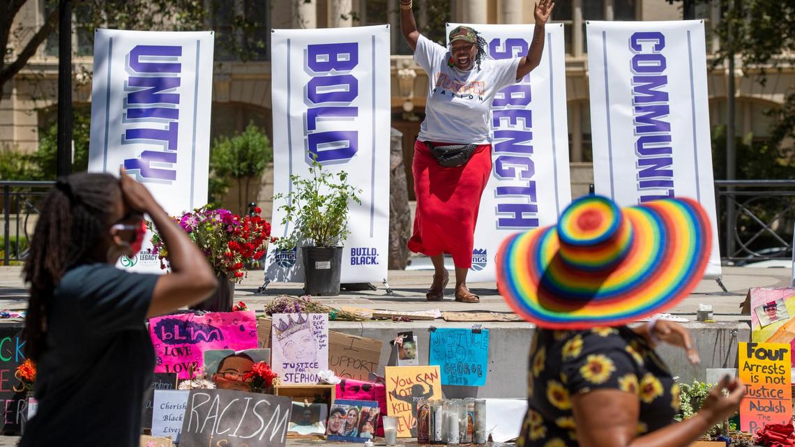 Coco Blossom Bland excites the crowd from the stage at Sacramento’s Cesar Chavez Park as she leads people in the “Wobble” line dance during a Juneteenth celebration Friday, June 19, 2020.