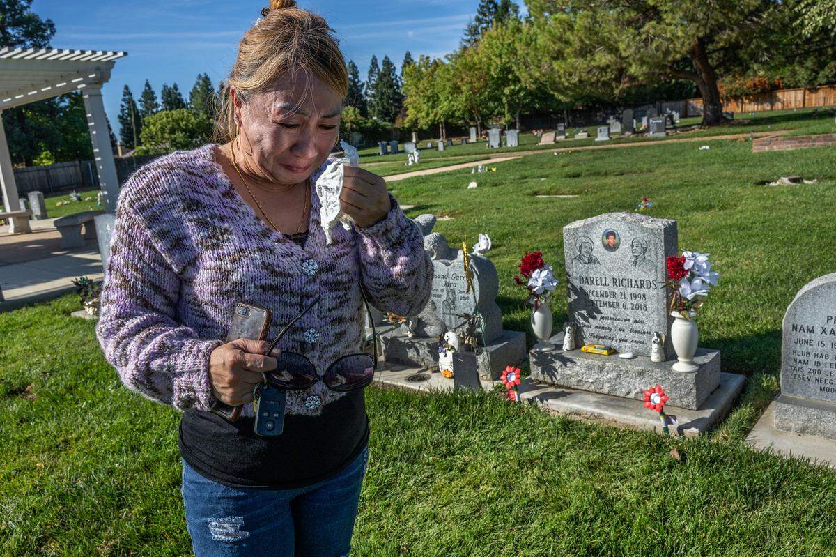 Khoua “Christine” Vang sobs after drying her eyes from tears as she visits her son Darell Richards’ grave on Monday in Elk Grove. “I’m disappointed in the entire system. I feel like everyone failed my son,” Vang said.