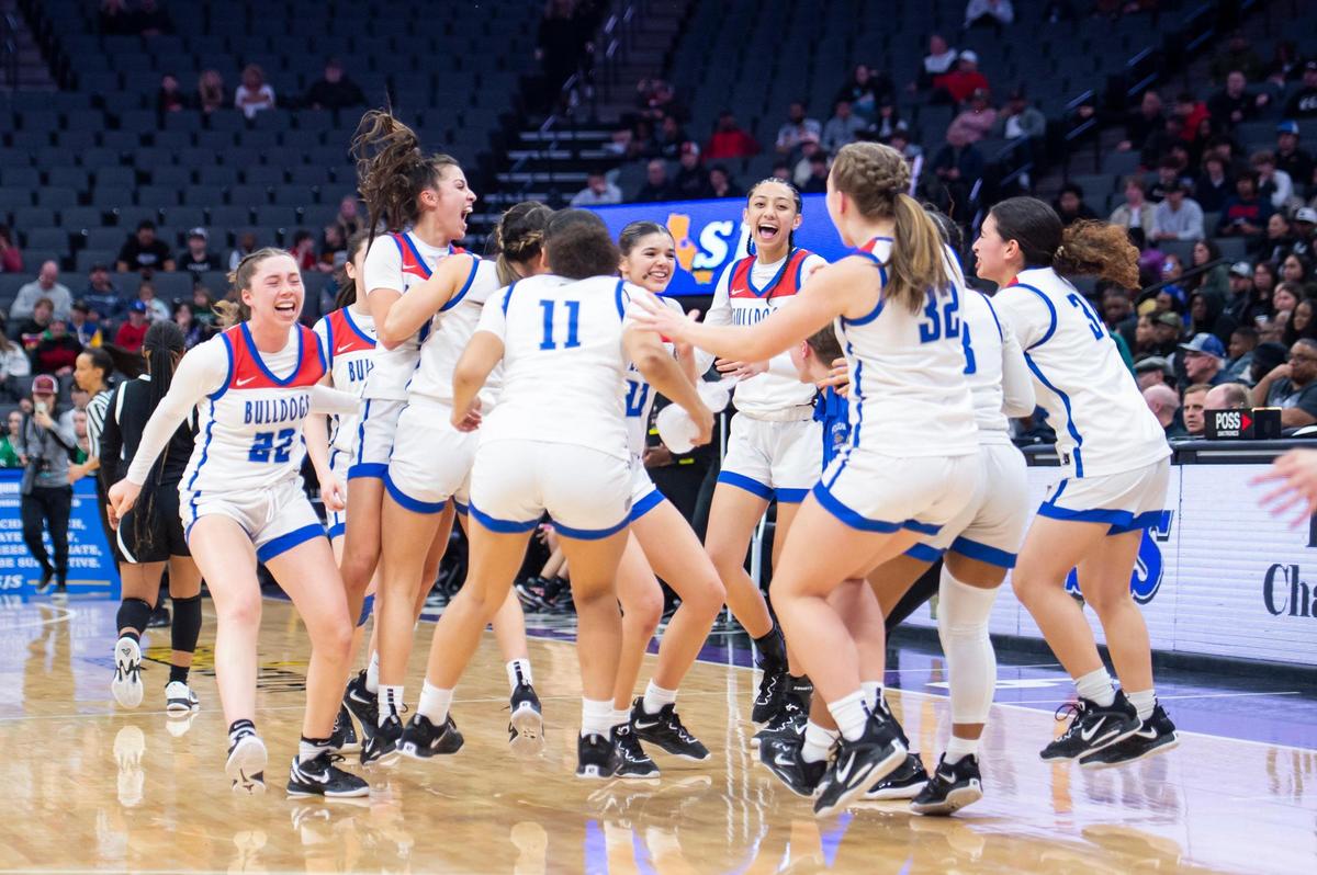 The Folsom Bulldogs celebrate after winning the CIF Sac-Joaquin Section Division I girls basketball championship against the St. Mary’s Rams on Saturday, Feb. 25, 2023, at Golden 1 Center in Sacramento. The Bulldogs won 58-53.