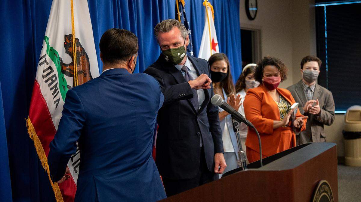 Attorney General Rob Bonta bumps elbows with California Gov. Gavin Newsom after he was sworn in as Californias 34th Attorney General during a ceremony on Friday, April 23, 2021, in Sacramento. Bonta, 49, will become the first Filipino American to head the California Department of Justice.