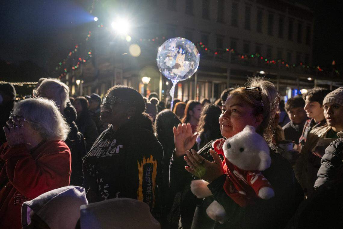 Christina Parra of Elk Grove claps during a dance performance at the Theatre of Lights tree lighting ceremony in Old Sacramento on Wednesday.
