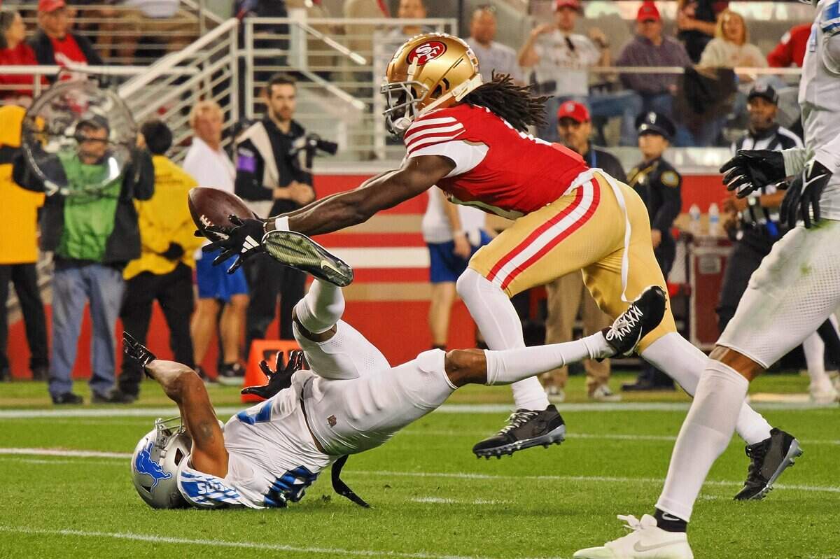 San Francisco 49ers wide receiver Brandon Aiyuk (11) catches a ball that bounced off the face mask of Detroit Lions cornerback Kindle Vildor (29) during the second half of the NFC Championship football game Jan 28, 2024 at Levi’s Stadium in Santa Clara.