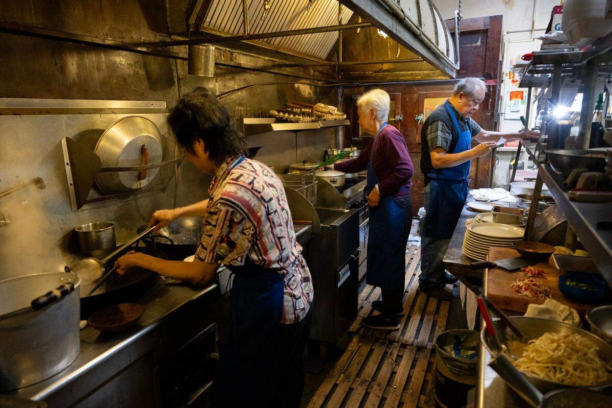 Nancy Fong, left, and her husband Paul prepare orders with sister-in-law Elisa Fong, center, for their customers.