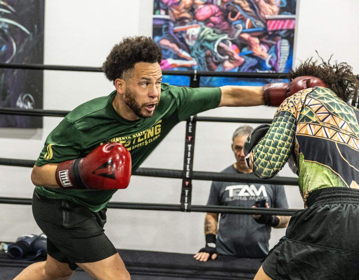 Sacramento State President Luke Wood, who is looking to bring back boxing to the university, trains on Sunday with amateur boxer Demitri Duruisseau at at Urijah Faber’s Ultimate Fitness in East Sacramento.