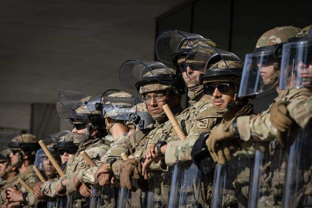 Federal officers and the National Guard protect the federal building in downtown Los Angeles on June 10, 2025, after protests over immigration raids.