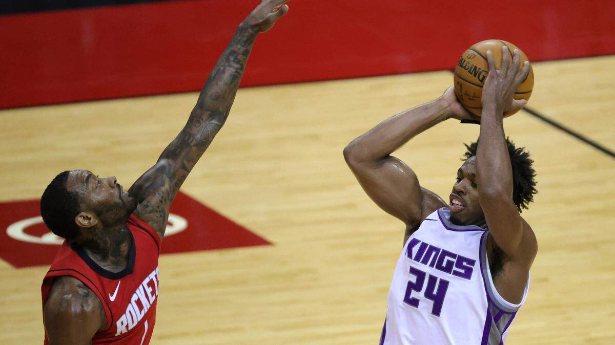 Sacramento Kings’ Buddy Hield (24) looks to pass ahead ofHouston Rockets’ John Wall (1) during the first quarter of an NBA basketball game Saturday, Jan. 2, 2021, in Houston. (Carmen Mandato/Pool Photo via AP)